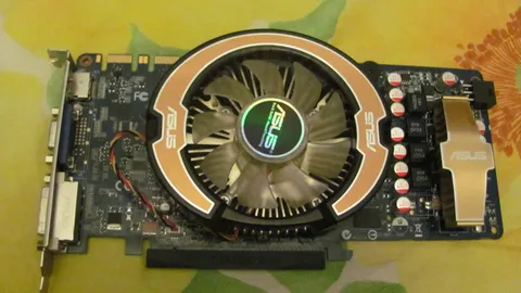 Graphics card with a large round cooling fan lying on a patterned cloth