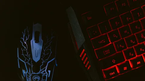 Close-up of a gaming mouse and backlit mechanical keyboard