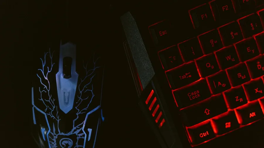 Close-up of a gaming mouse and backlit mechanical keyboard