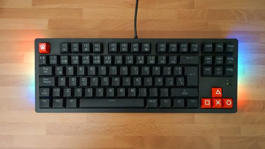 Tenkeyless mechanical keyboard with RGB underglow on a wooden desk