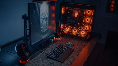 Gaming desk setup with a PC tower and dual monitors showing artwork